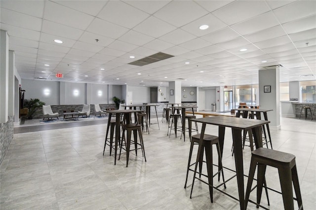 dining room featuring a drop ceiling