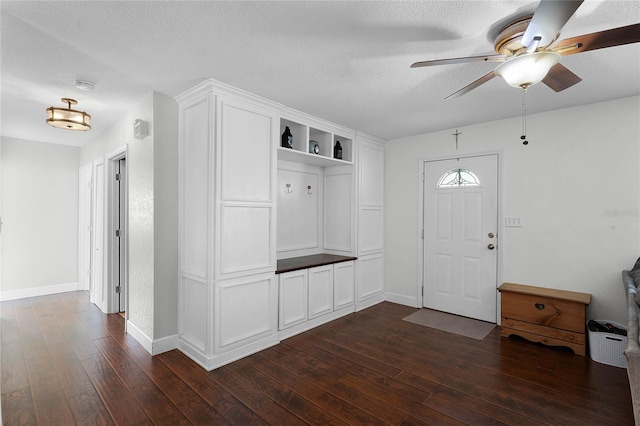 mudroom featuring ceiling fan, dark hardwood / wood-style floors, and a textured ceiling