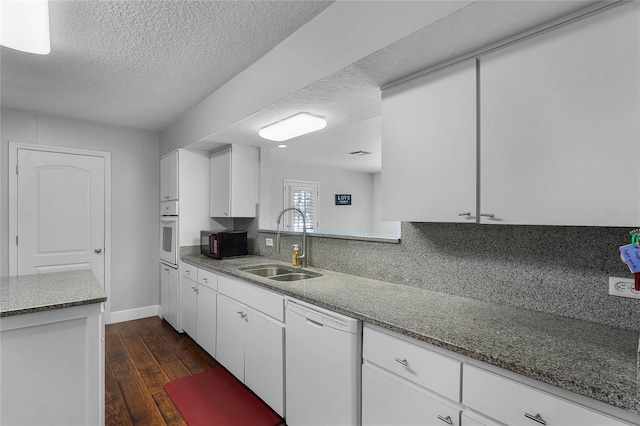 kitchen featuring sink, white appliances, dark wood-type flooring, and white cabinets