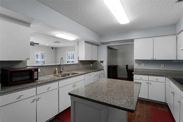 kitchen featuring sink, white cabinetry, a kitchen island, ceiling fan, and black appliances