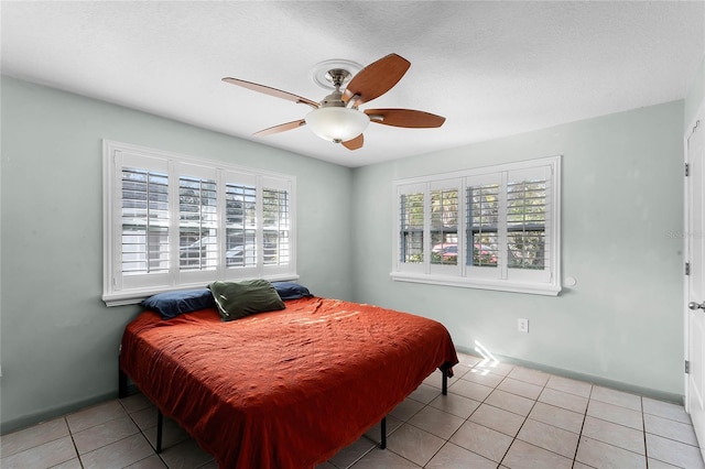 bedroom featuring light tile patterned floors and ceiling fan