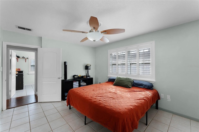 bedroom featuring light tile patterned floors and ceiling fan