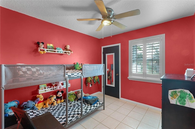 bedroom featuring light tile patterned floors, a textured ceiling, and ceiling fan