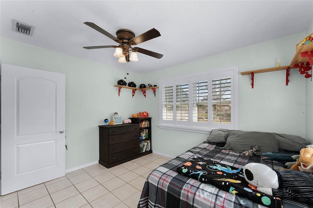 tiled bedroom featuring ceiling fan