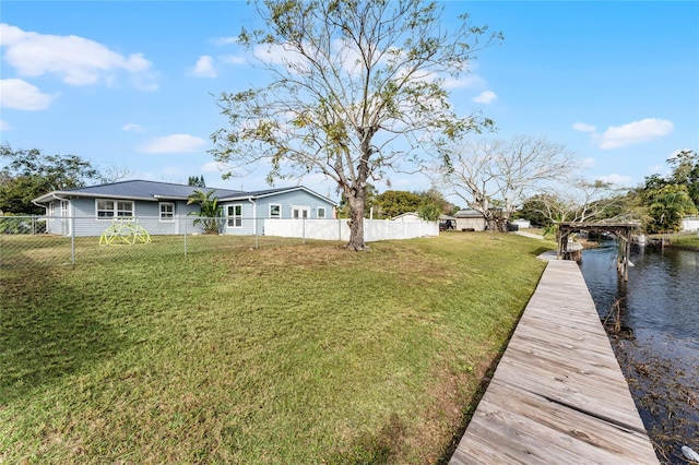 exterior space featuring a lawn and a water view