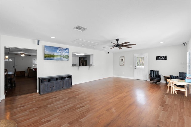 living room featuring hardwood / wood-style floors and ceiling fan