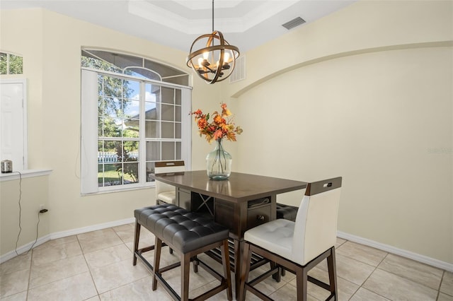 dining space with light tile patterned floors, a tray ceiling, an inviting chandelier, and plenty of natural light