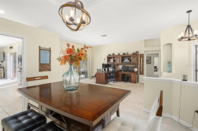 tiled dining room with an inviting chandelier