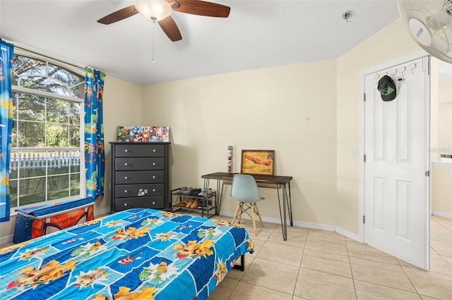 bedroom featuring light tile patterned floors and ceiling fan