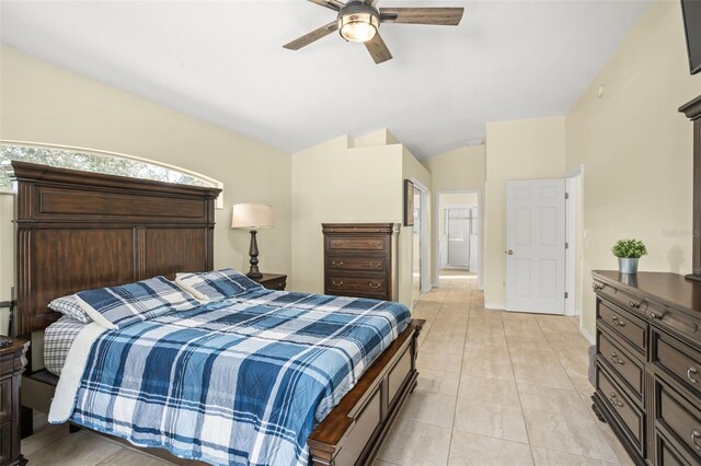 tiled bedroom featuring vaulted ceiling and ceiling fan