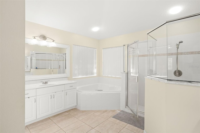 bathroom with shower with separate bathtub, vanity, and tile patterned floors