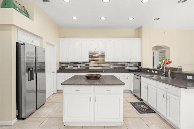 kitchen with kitchen peninsula, appliances with stainless steel finishes, white cabinetry, and sink