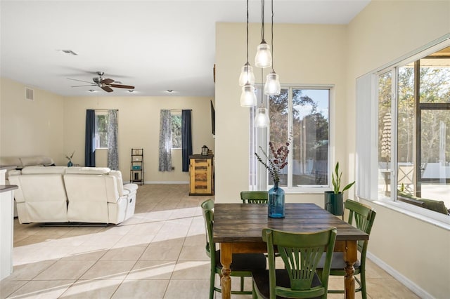 dining space featuring ceiling fan and light tile patterned flooring