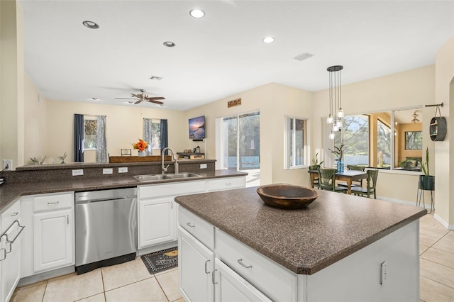 kitchen featuring stainless steel dishwasher, ceiling fan, sink, a center island, and white cabinetry