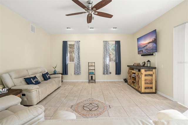 living room with ceiling fan and light tile patterned floors