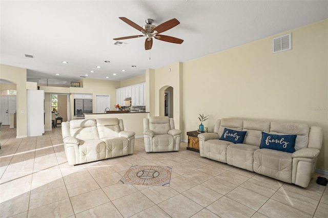 tiled living room featuring ceiling fan