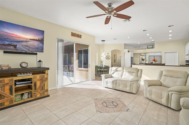 living room with ceiling fan and light tile patterned floors