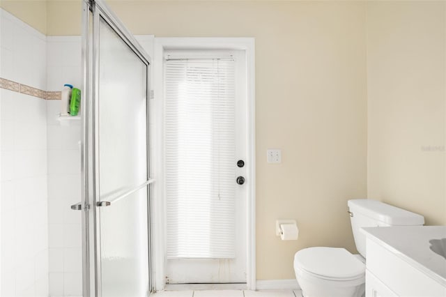 bathroom featuring a shower with door, vanity, and toilet