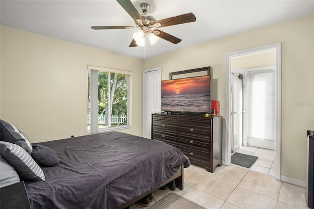 bedroom with ceiling fan and light tile patterned floors