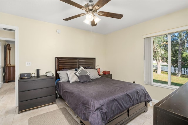 tiled bedroom featuring ceiling fan