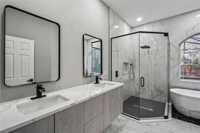 bathroom with vanity and shower with separate bathtub