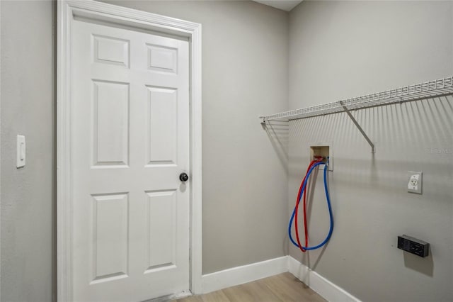 washroom with light hardwood / wood-style floors and washer hookup