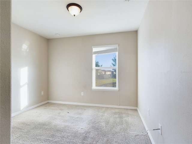 unfurnished room featuring light carpet