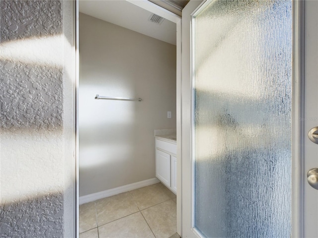 bathroom with tile patterned flooring and an enclosed shower