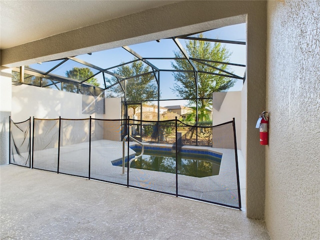 view of swimming pool featuring a lanai and a patio