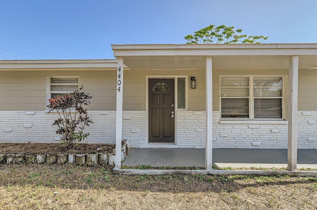 doorway to property with a porch