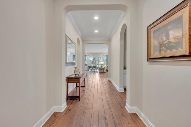 hall with wood-type flooring and crown molding