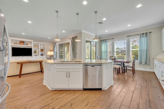 kitchen with pendant lighting, sink, white cabinetry, and stainless steel appliances