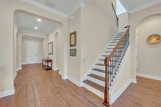 interior space with light hardwood / wood-style floors and ornamental molding