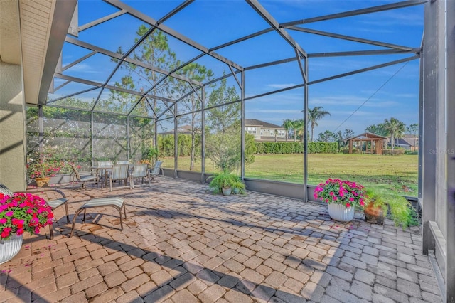 view of patio with glass enclosure