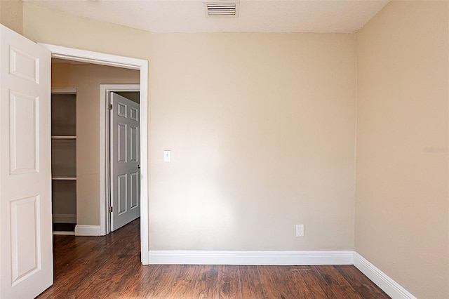 spare room featuring dark hardwood / wood-style floors