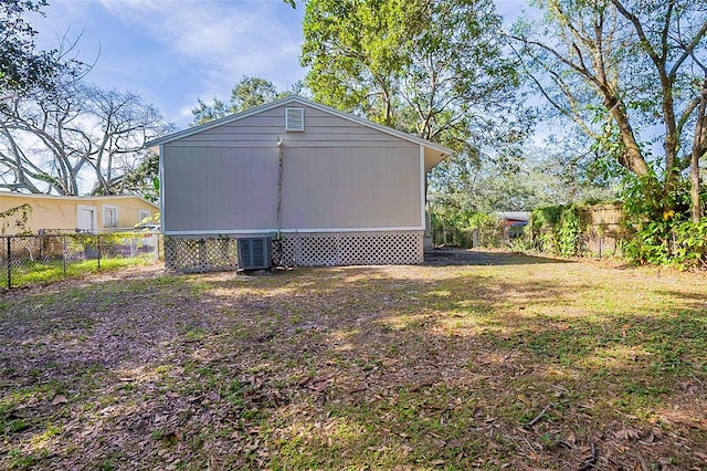 view of home's exterior featuring central air condition unit and a lawn