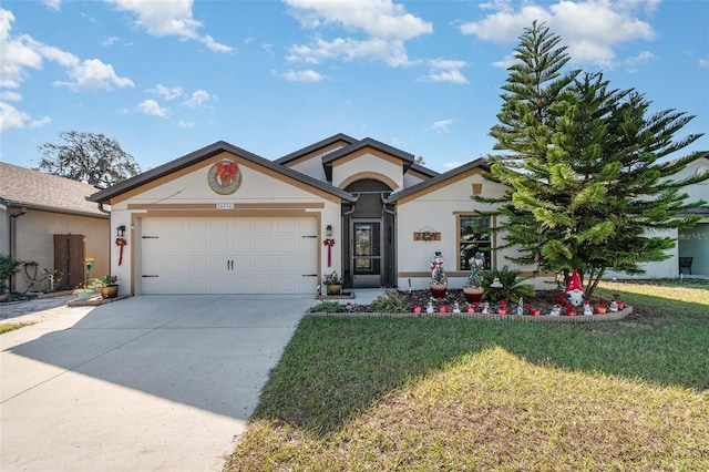 view of front of property featuring a front lawn and a garage