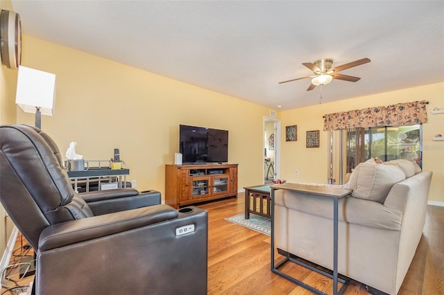 living room featuring light hardwood / wood-style flooring and ceiling fan