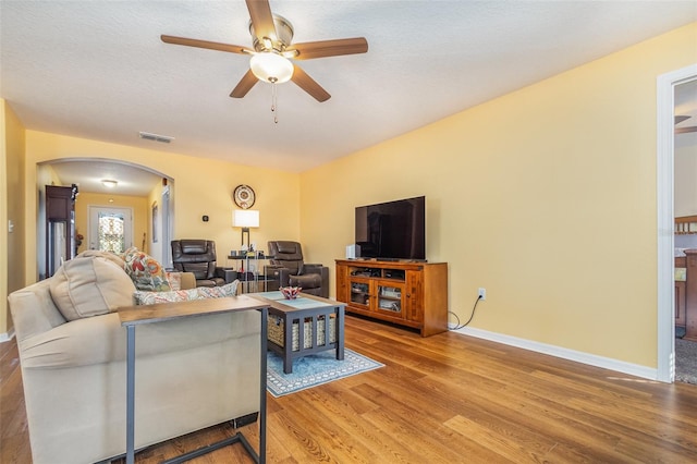 living room with ceiling fan and hardwood / wood-style flooring