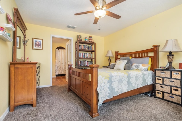 bedroom featuring ceiling fan and dark carpet