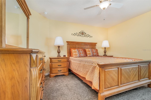 bedroom featuring dark carpet and ceiling fan