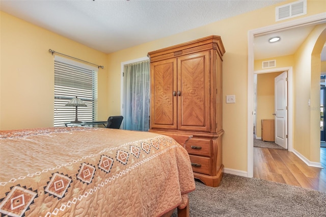 carpeted bedroom featuring a textured ceiling