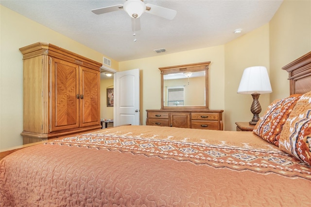 bedroom featuring a textured ceiling and ceiling fan