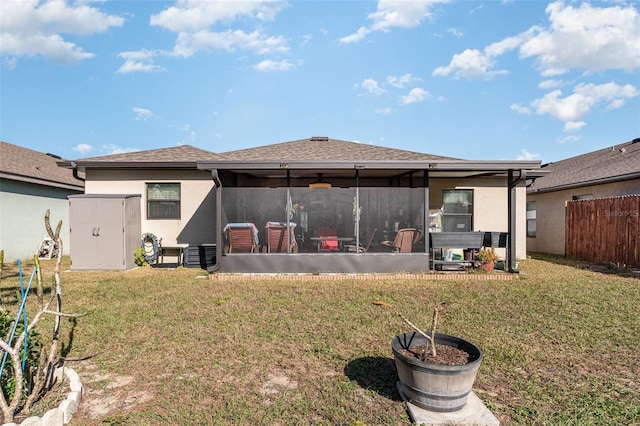 rear view of property with a sunroom and a yard