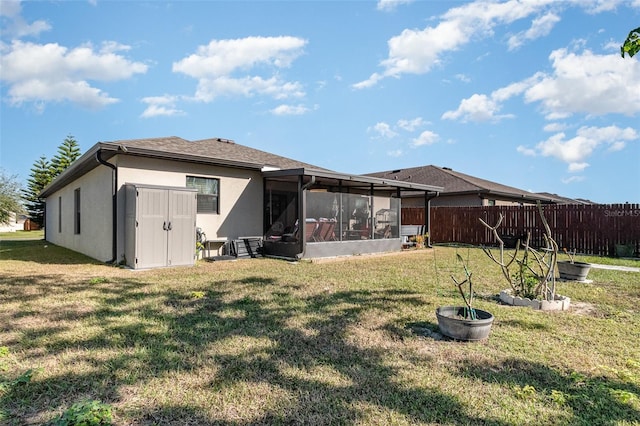 back of property with a sunroom and a yard