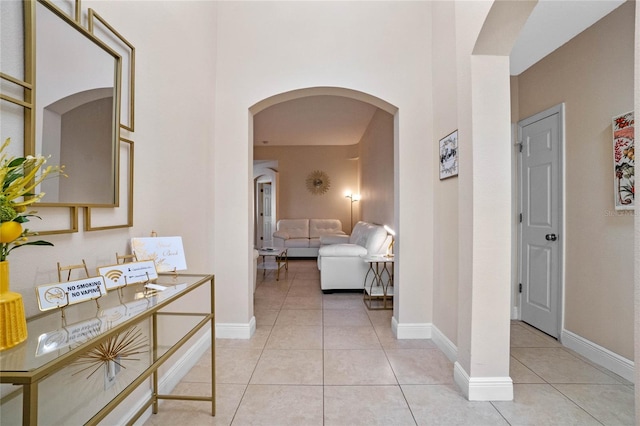 hall featuring light tile patterned flooring