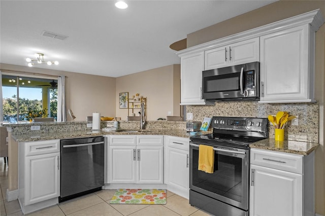 kitchen with white cabinetry, stainless steel appliances, kitchen peninsula, and sink