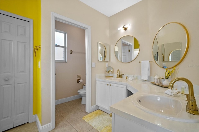 bathroom with vanity, tile patterned floors, and toilet