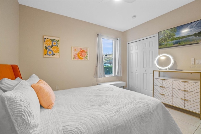 bedroom with light tile patterned floors and a closet