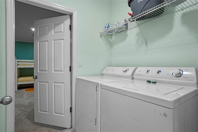 clothes washing area featuring separate washer and dryer and carpet flooring